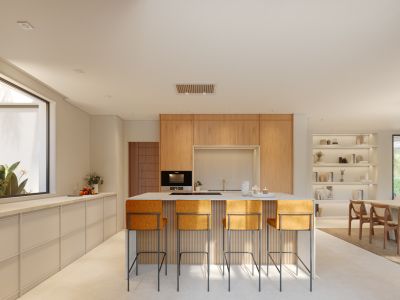 Cuisine ouverte contemporaine avec îlot central, comptoir clair et quatre tabourets de bar orange. Armoires en bois intégrées et éclairage encastré caractérisent l'espace.