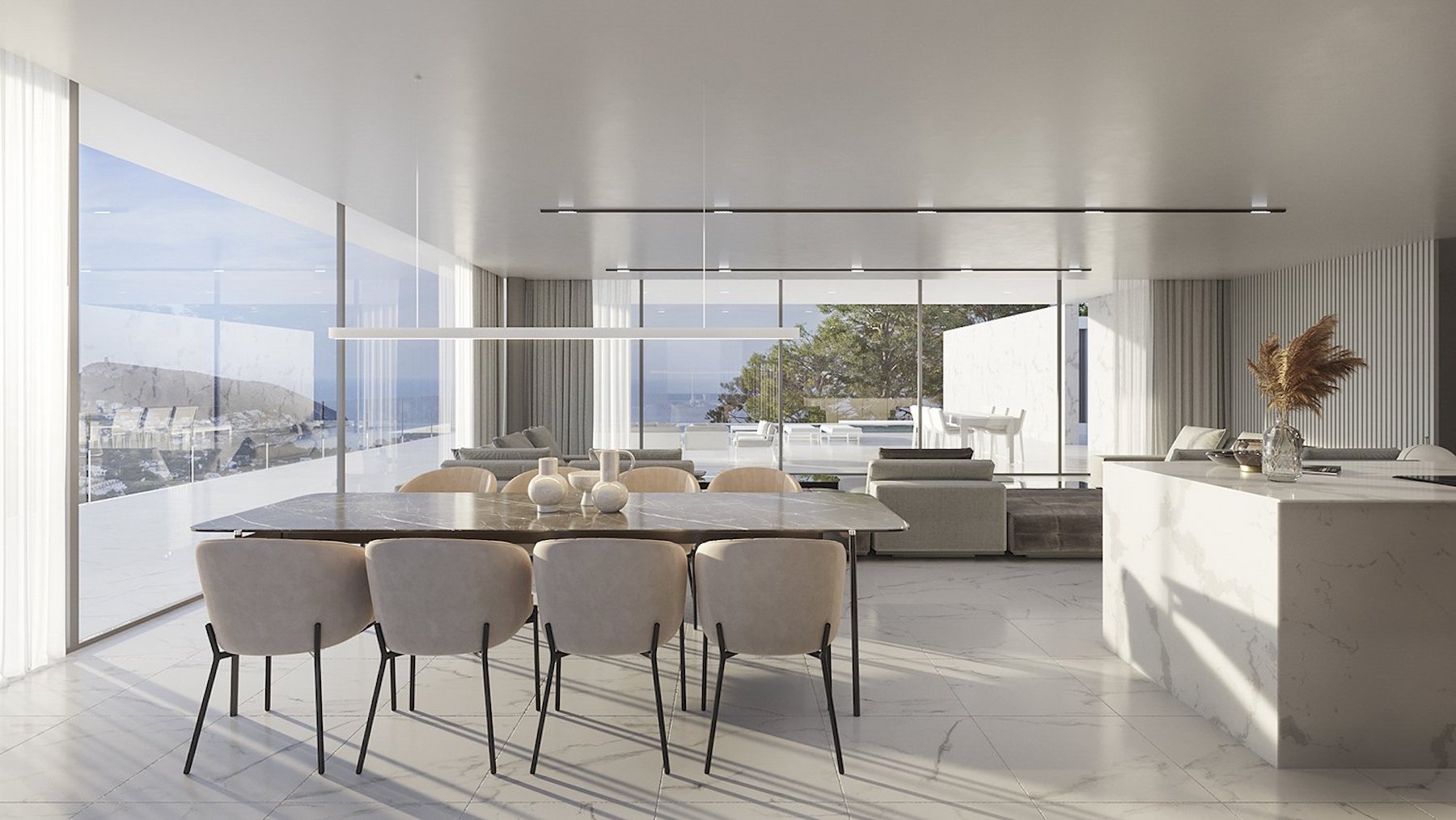 Espace de vie ouvert avec table en marbre sombre, îlot de cuisine en pierre blanche et baies vitrées offrant une vue panoramique sur la mer.