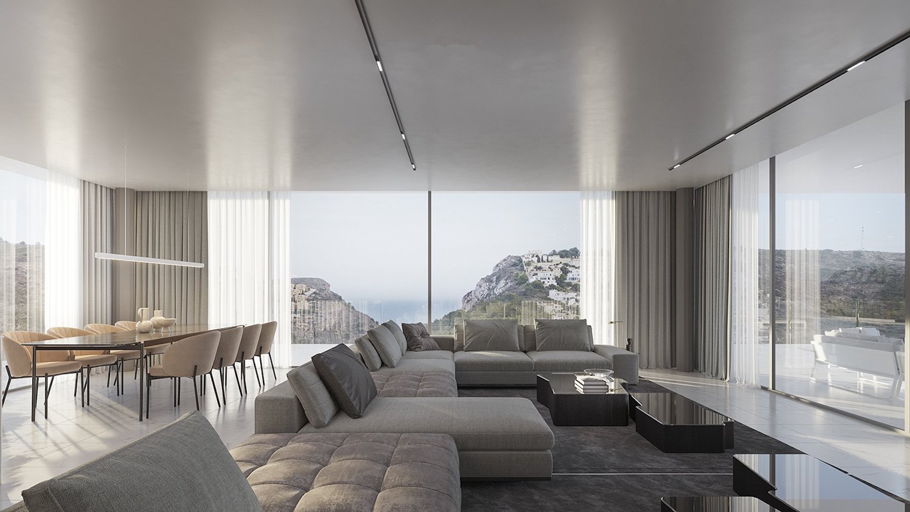 Espace de vie ouvert comprenant un salon et une salle à manger avec de larges baies vitrées offrant une vue panoramique sur la mer et les falaises environnantes.