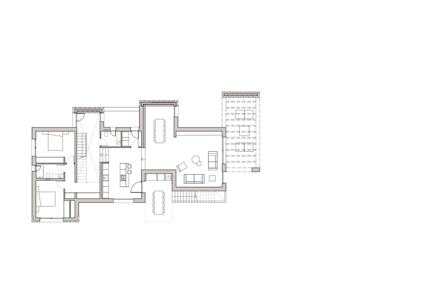 Plan d'architecte du rez-de-chaussée détaillant l'espace de vie ouvert, la cuisine avec îlot, les chambres avec salles de bains et les généreuses terrasses extérieures.