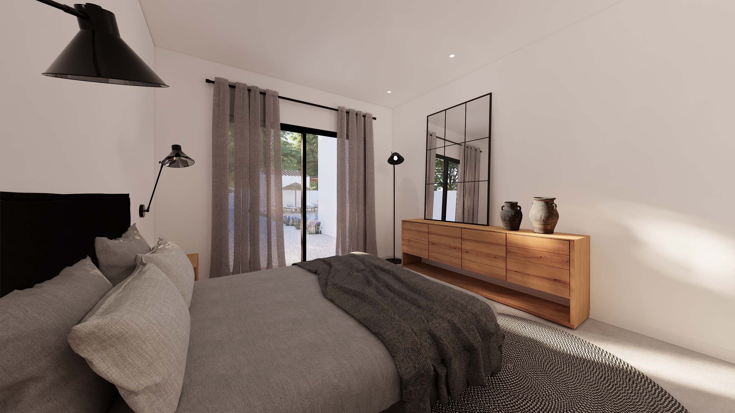 Chambre avec buffet en bois, miroir de style industriel et accès direct au jardin par de larges baies vitrées aux rideaux de lin.