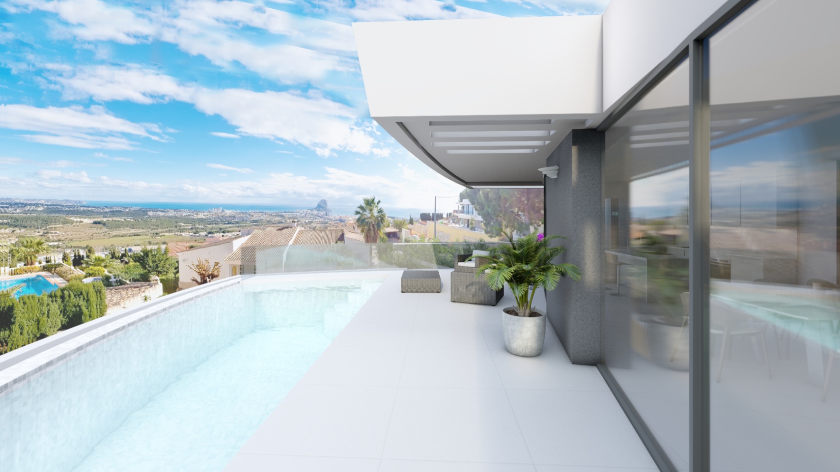 Terrasse avec piscine à débordement, garde-corps en verre et vue sur le Peñón de Ifach. Les grandes baies vitrées relient l'espace extérieur carrelé de blanc à l'intérieur.