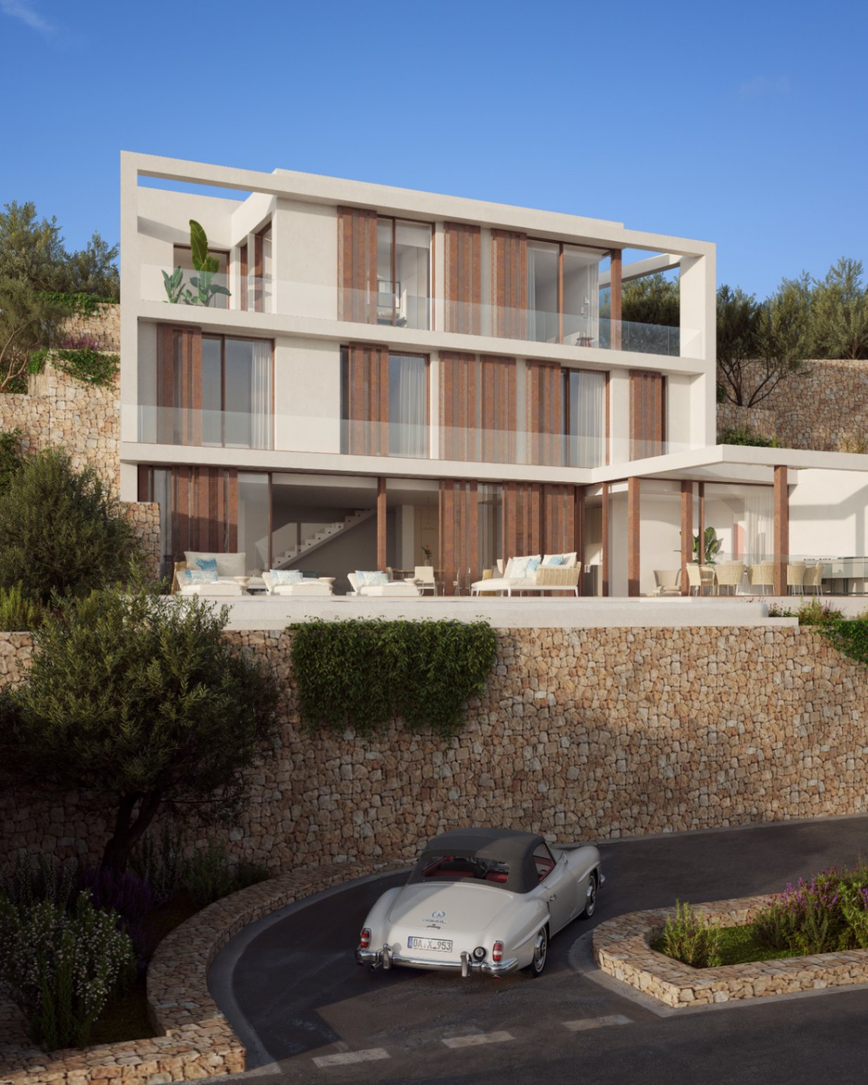 Façade à trois niveaux avec murs en pierre naturelle, persiennes en bois et larges terrasses vitrées. L'extérieur dispose d'un espace lounge et d'un jardin méditerranéen en restanques.