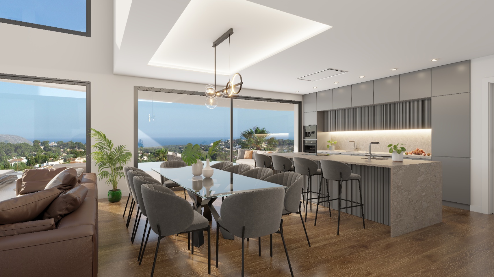 Espace de vie ouvert comprenant une salle à manger et une cuisine moderne avec îlot en pierre. Les grandes baies vitrées offrent une vue panoramique sur la mer.