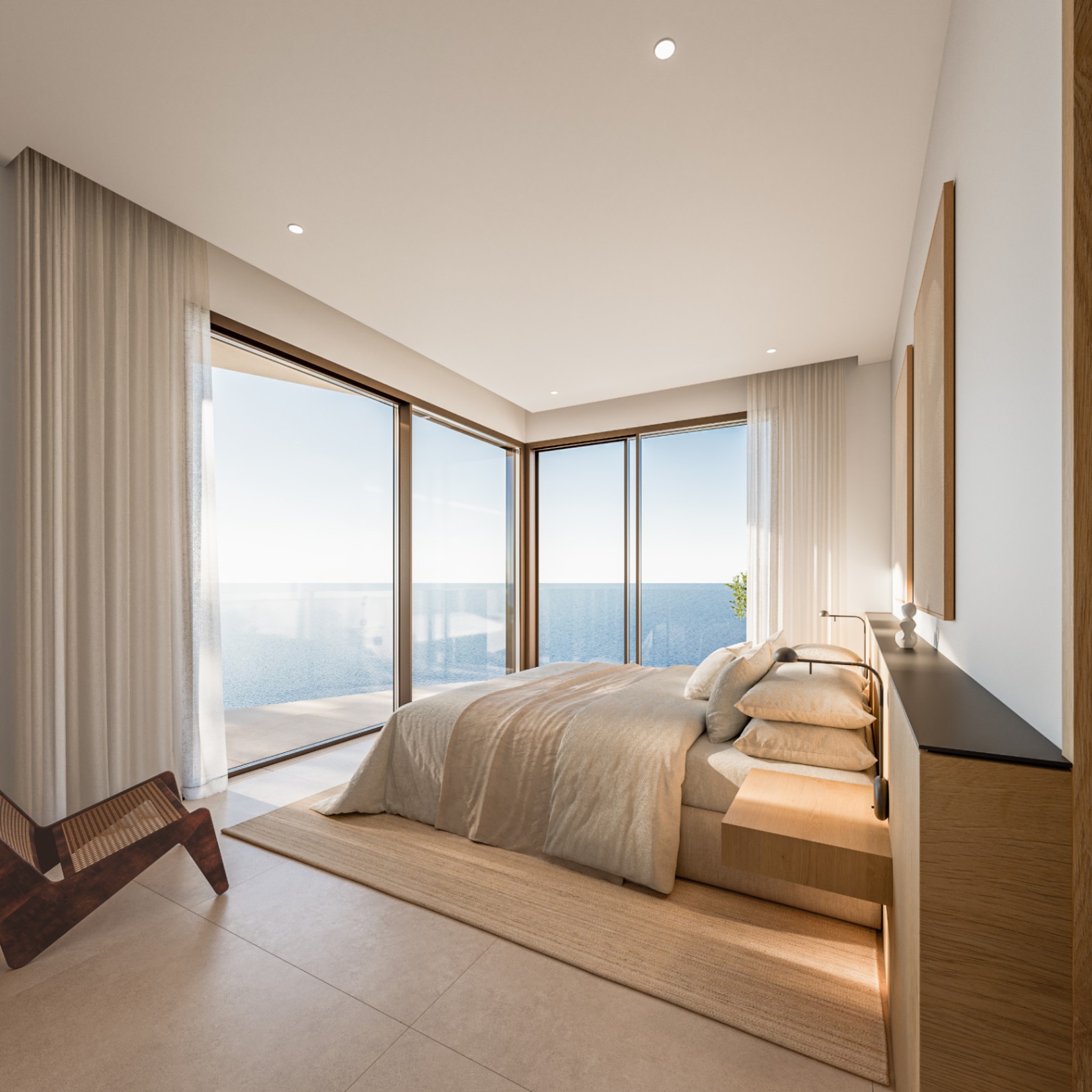 Chambre principale avec baies vitrées d'angle offrant une vue sur la mer. Design minimaliste avec mobilier en bois intégré, éclairage encastré et tons neutres.