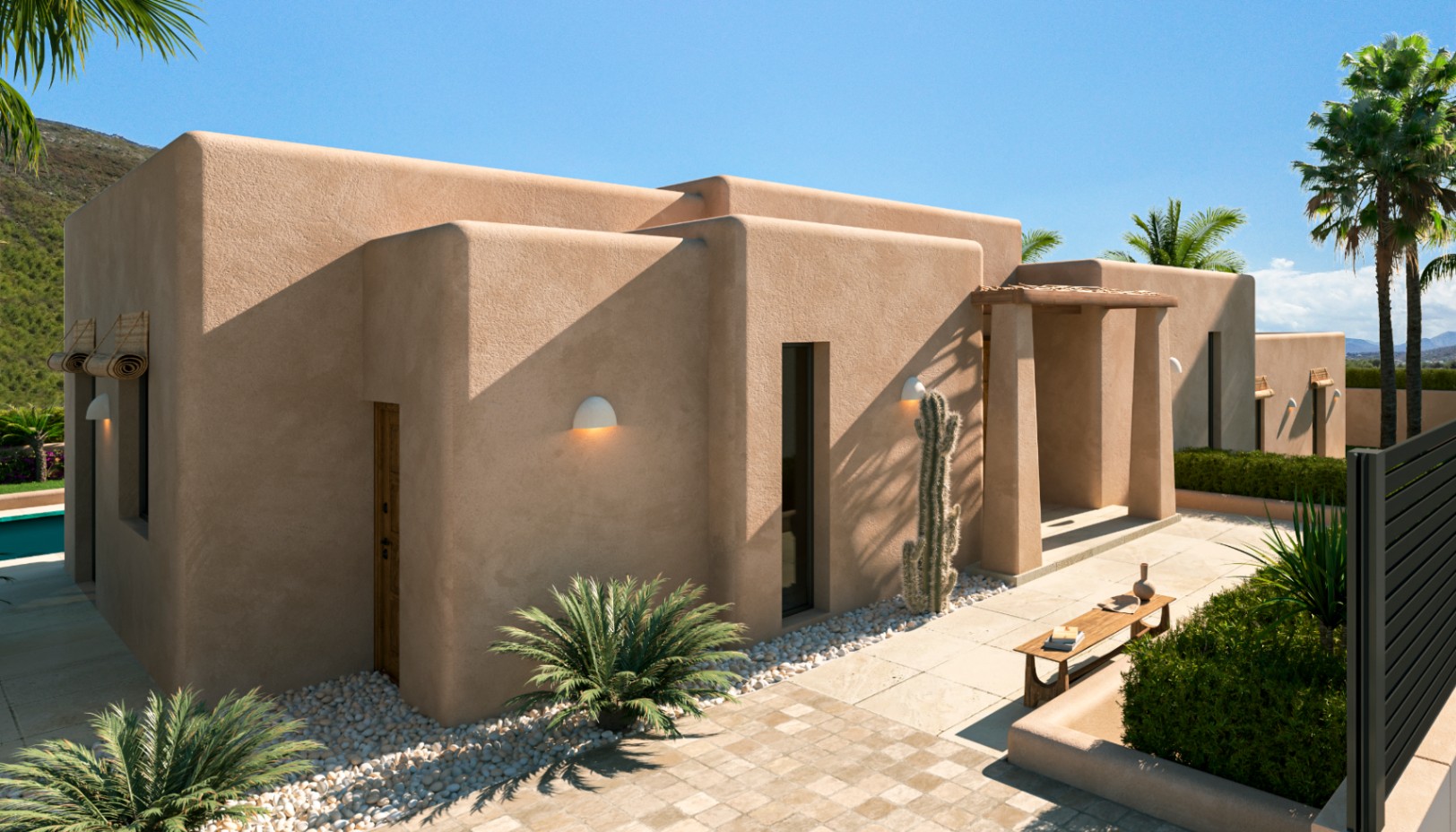 Extérieur méditerranéen contemporain aux murs de stuc ocre, lignes épurées et jardin paysager avec cactus, palmiers et allées en pierre naturelle.