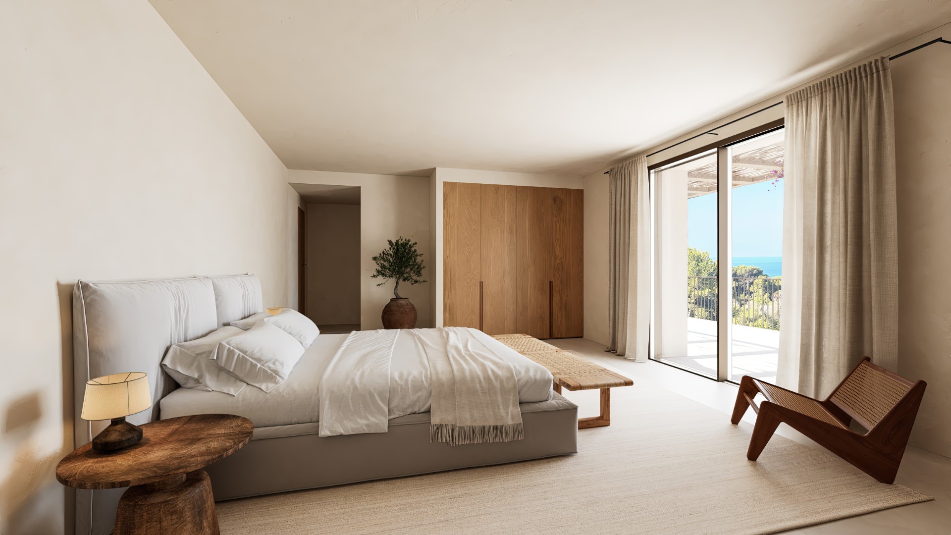 Chambre principale avec placards en chêne, mobilier épuré en bois et grandes baies vitrées ouvrant sur une terrasse privée face à la mer Méditerranée.