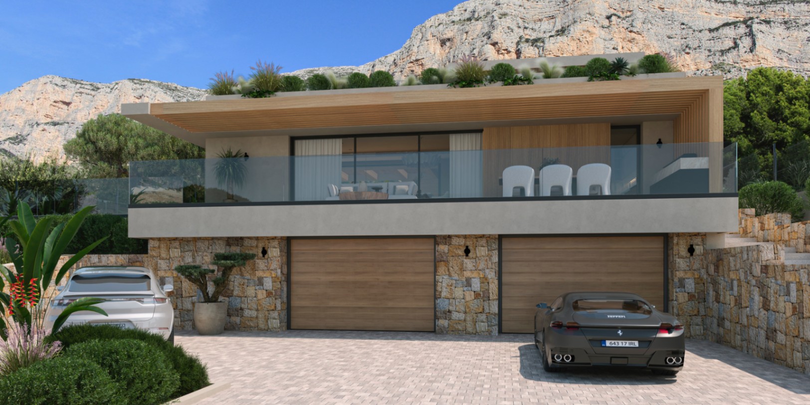 Façade extérieure avec murs en pierre naturelle, double garage en bois et terrasse à balustrade en verre offrant une vue sur la montagne Montgó.