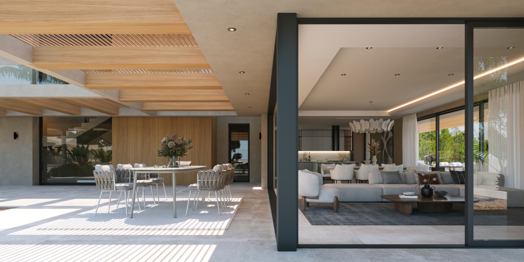 Terrasse extérieure avec pergola en bois et salle à manger, reliée par de grandes baies vitrées au salon ouvert et à la cuisine moderne.