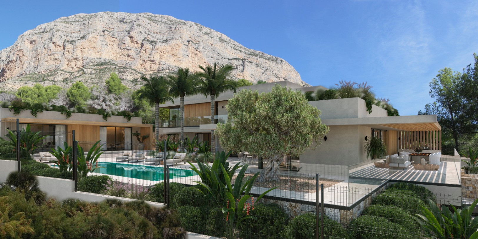 Vue extérieure de la villa avec piscine turquoise, terrasse en pierre et jardin méditerranéen au pied de l'imposante montagne Montgó à Jávea.