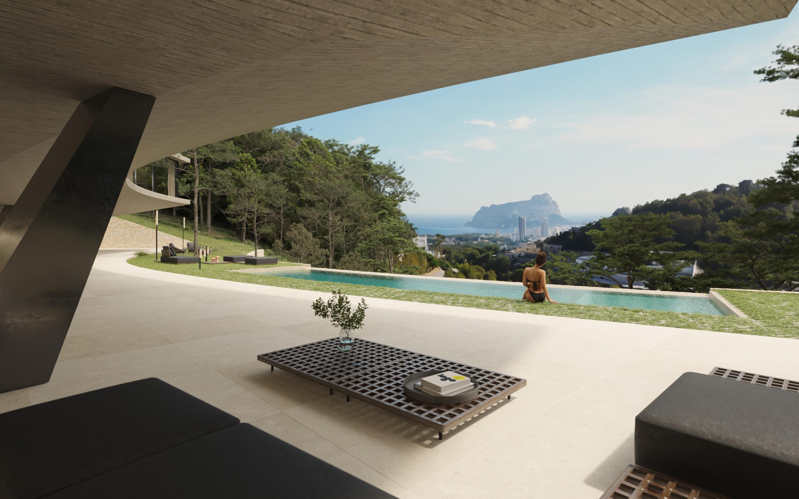 Terrasse moderne avec plafond en béton brut, piscine à débordement et vue panoramique sur le Peñón de Ifach et le littoral méditerranéen.