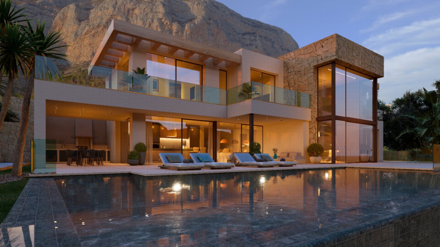 Façade moderne avec murs en pierre naturelle, grandes baies vitrées et piscine. La terrasse éclairée comprend un coin repas extérieur au pied du mont Montgó.