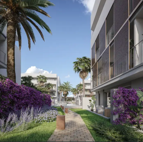 Une allée pavée traverse des jardins méditerranéens paysagers avec des bougainvilliers violets, des palmiers et des façades modernes aux persiennes verticales.