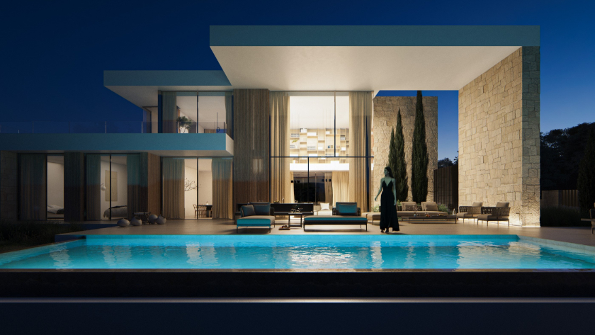 Vue extérieure au crépuscule avec piscine à débordement, murs en pierre naturelle et terrasse à double hauteur équipée d'un mobilier contemporain.