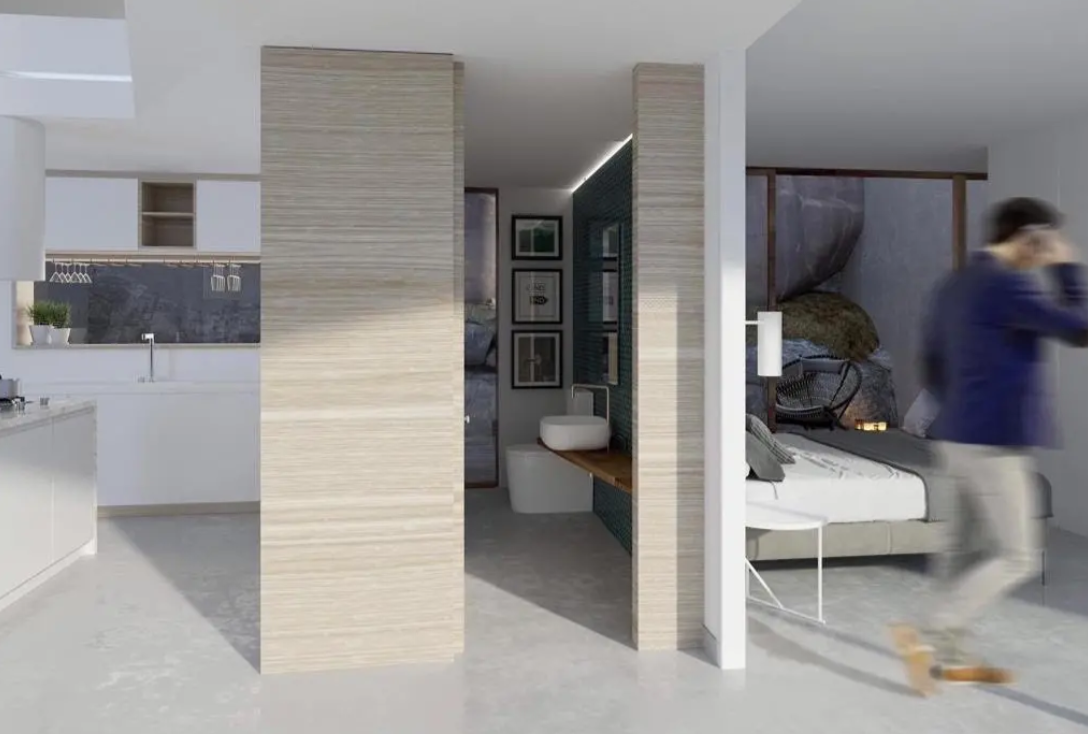 Suite à aire ouverte comprenant une cuisine blanche intégrée, une salle de bain avec vasque à poser et une chambre avec vue sur paroi rocheuse. Cloisons en bois clair.