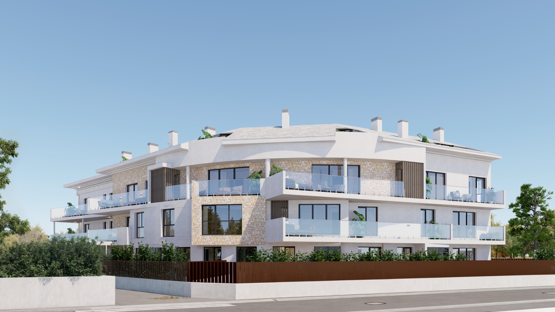 Vue extérieure du bâtiment de trois étages avec façade blanche, parements en pierre naturelle, terrasses incurvées en verre et menuiseries sombres.