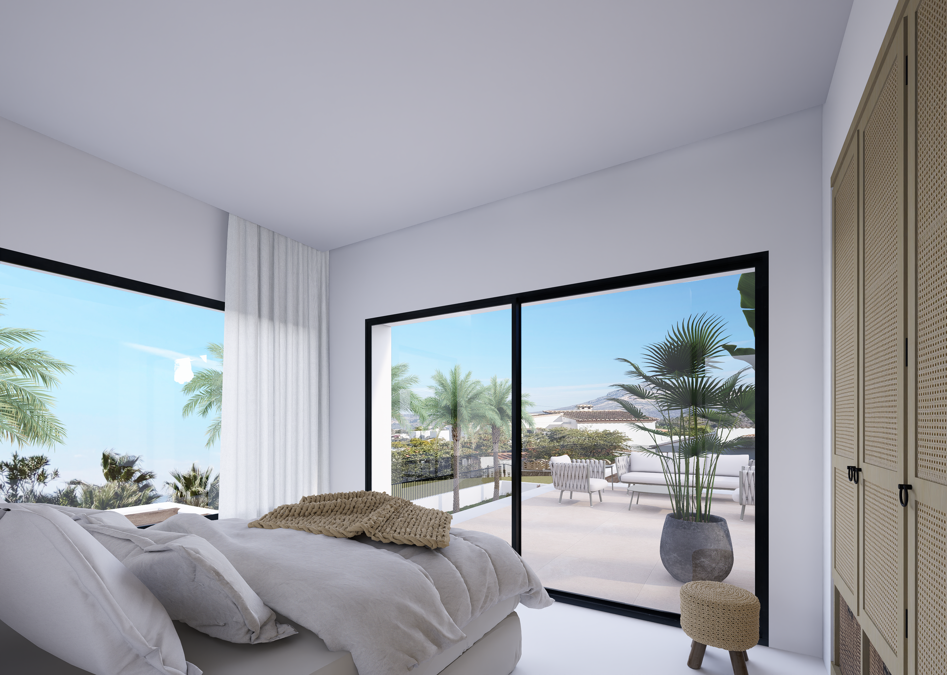 Chambre moderne avec de larges baies vitrées coulissantes ouvrant sur la terrasse. Elle dispose de placards intégrés en rotin et offre une vue sur le mont Montgó.