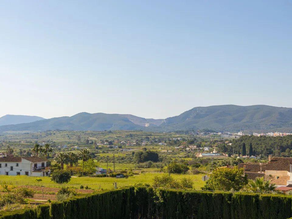 Vues panoramiques dégagées sur la vallée et les montagnes de la Costa Blanca, illustrant le paysage rural et la végétation méditerranéenne depuis la terrasse.