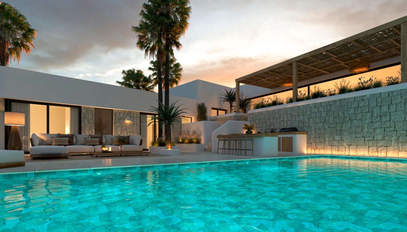 Espace extérieur avec piscine illuminée, cuisine d'été et salon lounge. Murs en pierre naturelle, pergola en bois et palmiers créent une ambiance élégante au crépuscule.