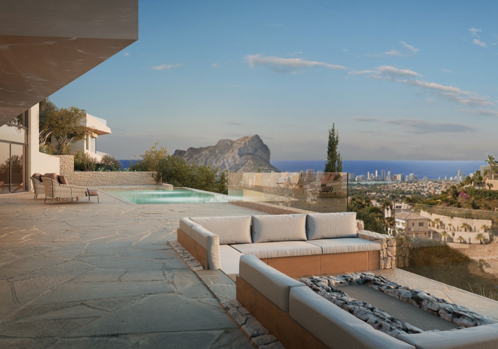 Terrasse avec piscine et vue sur mer. Mobilier d'extérieur avec base en pierre et dalles irrégulières.
